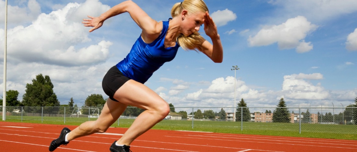 Track athlete exploding out of the starting blocks